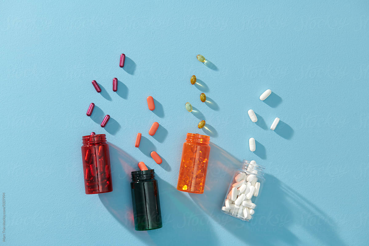 Medicinal capsule spill out of a four plastic bottles