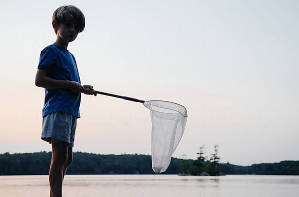 Young Boy Fishing On Lake Almanor by Stocksy Contributor