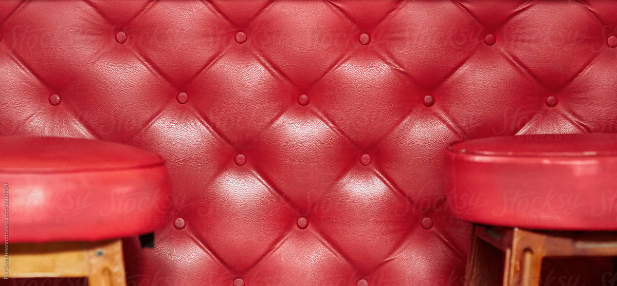 Red wall with leather bar chairs