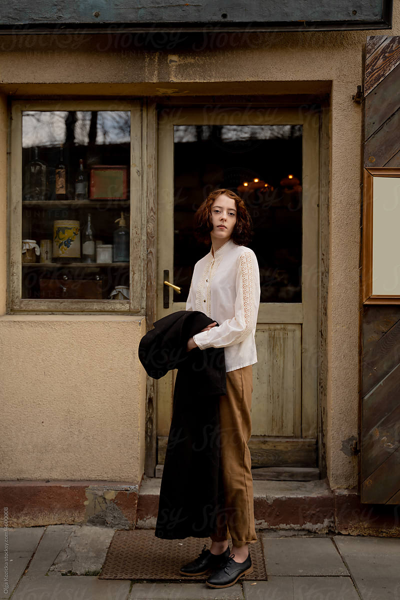 Woman Standing In Front Of Vintage Grocery Store