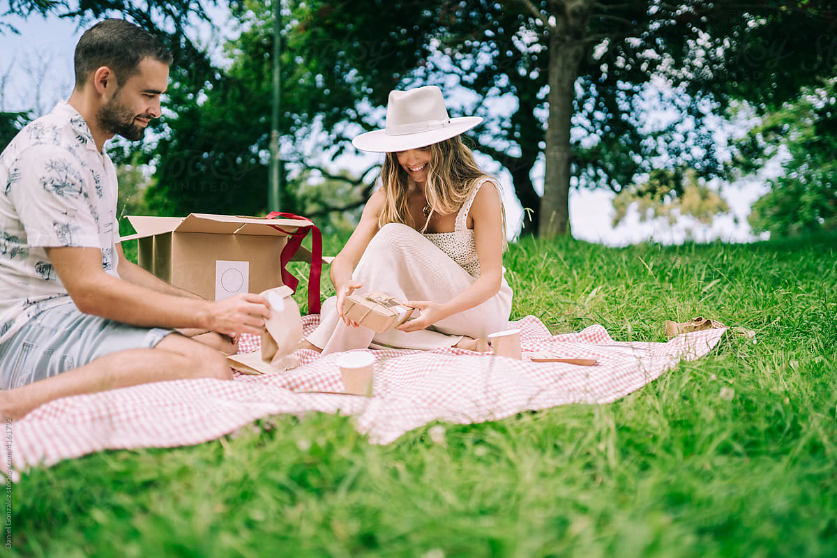 Couple preparing for picnic in countryside