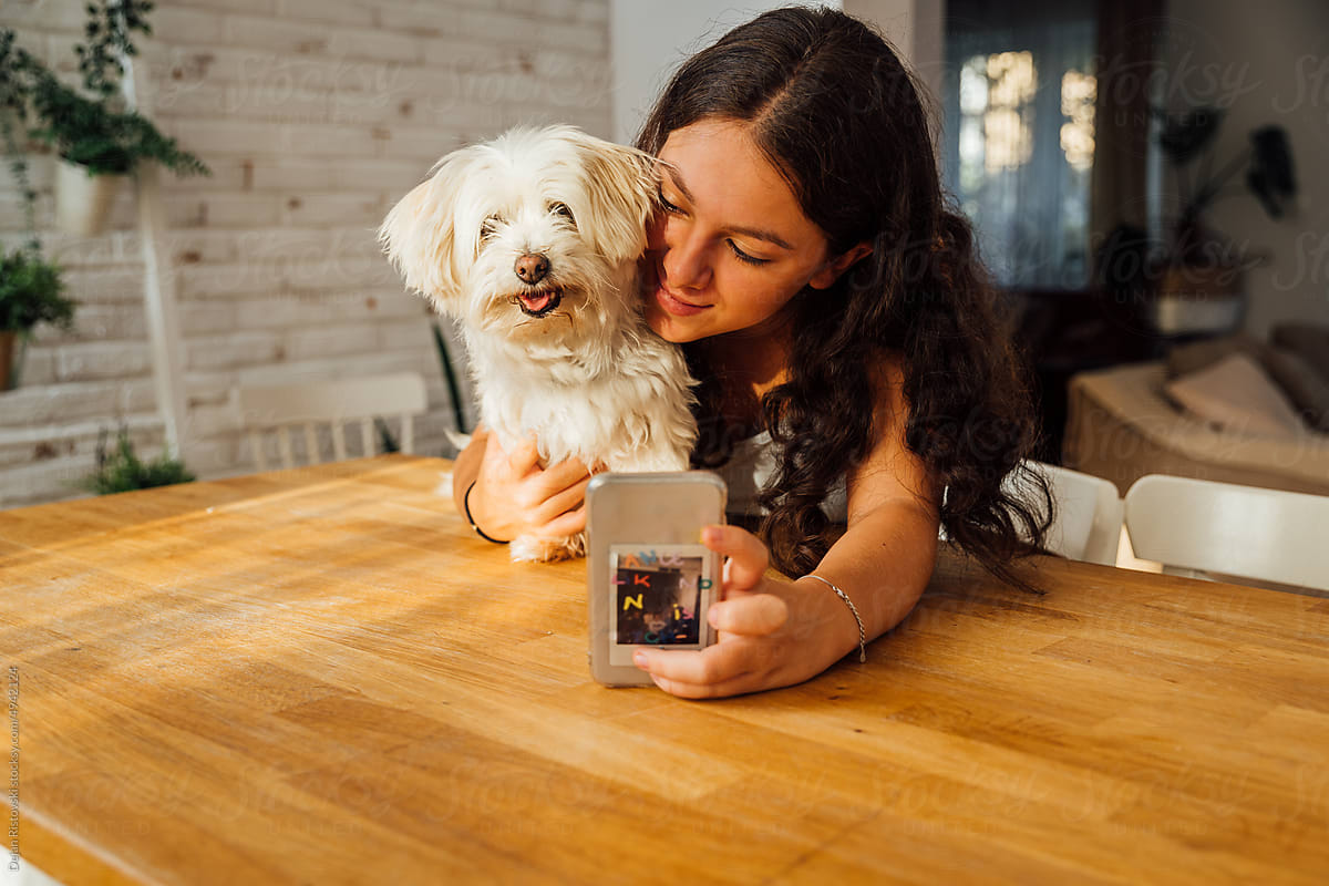 Girl taking selfie with her dog