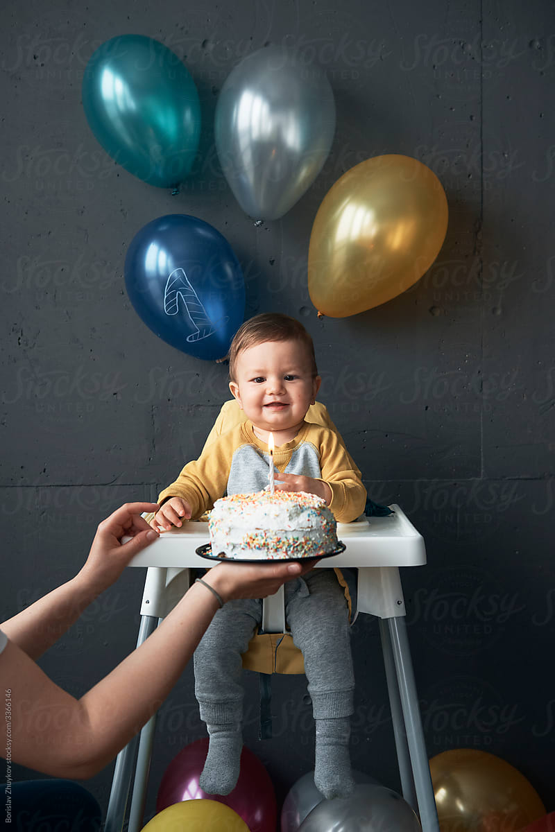 Baby boy enjoy first birthday celebration cake.