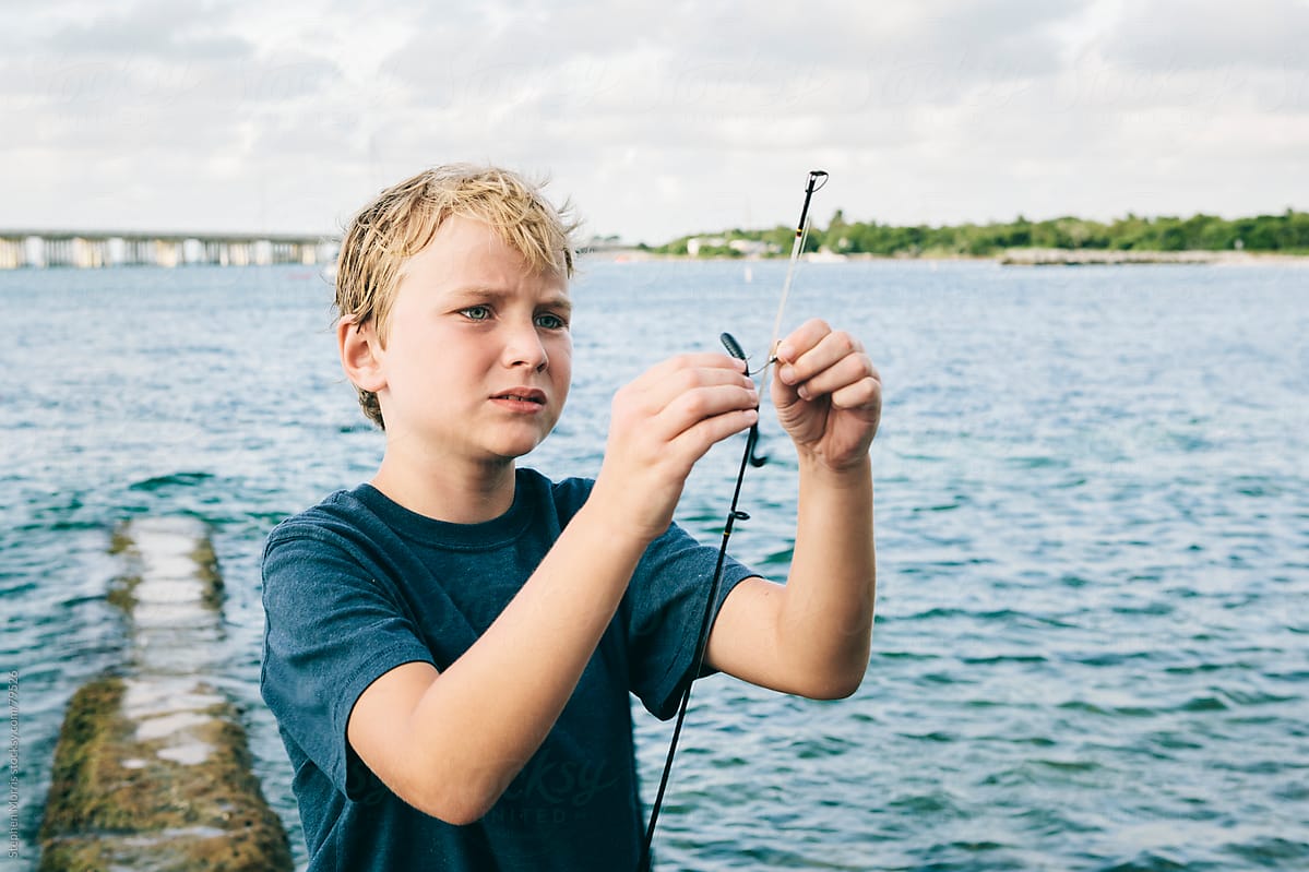 Boy Baiting Hook For Fishing by Stocksy Contributor Stephen