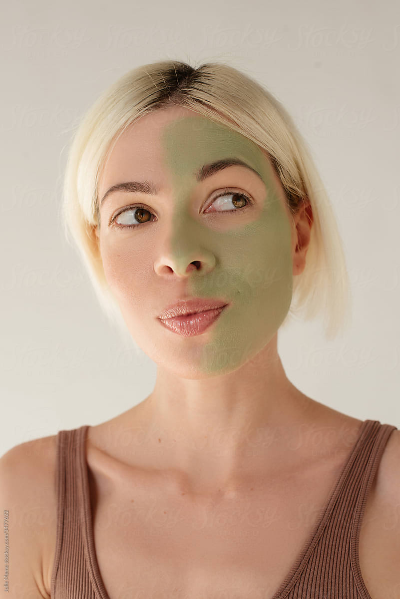 A blond girl with half of face cover with mask