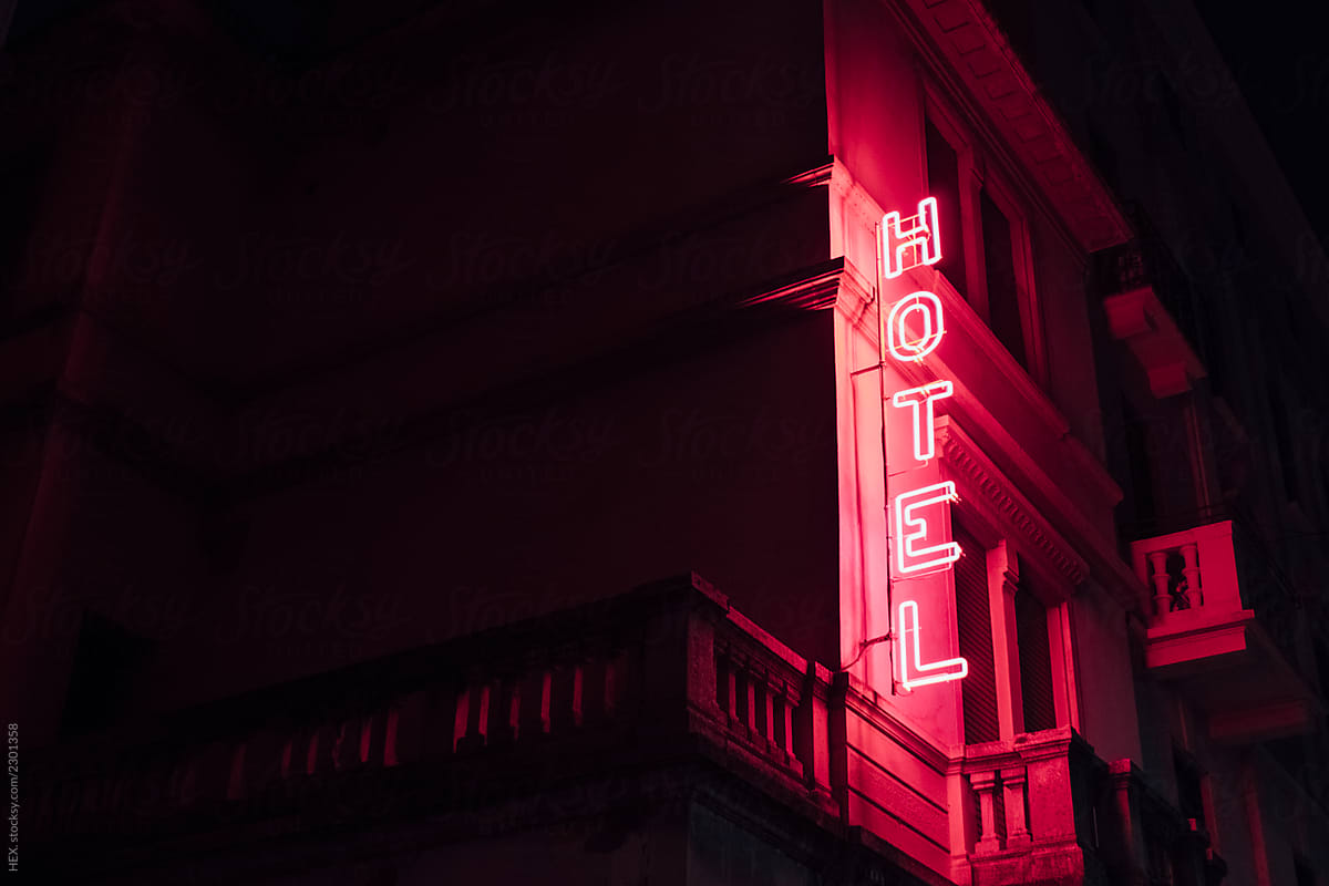 Pink Cool Red Hotel Sign Glowing in the Dark City . City