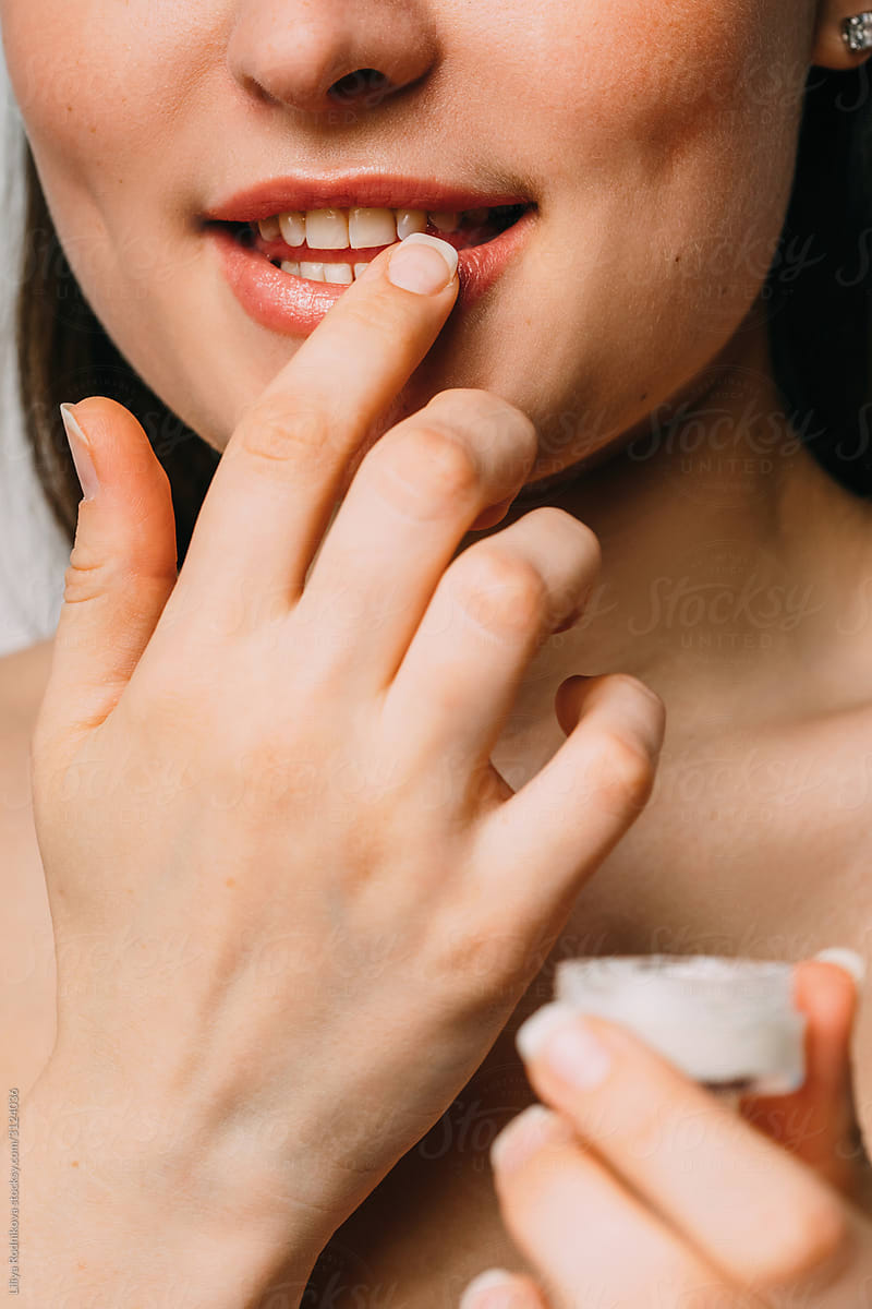 Anonymous woman applying lip balm
