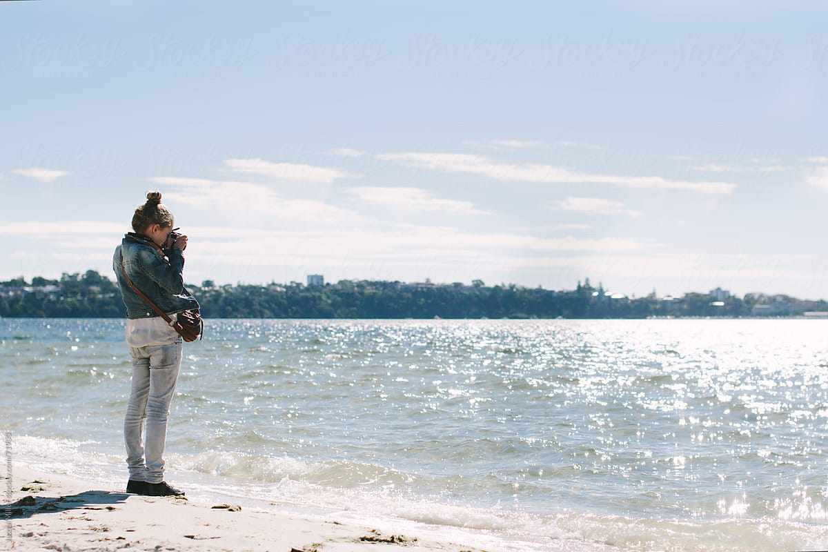 Girl Taking Photograph Of Water With Copy Space By Stocksy Contributor Jacqui Miller Stocksy 6163