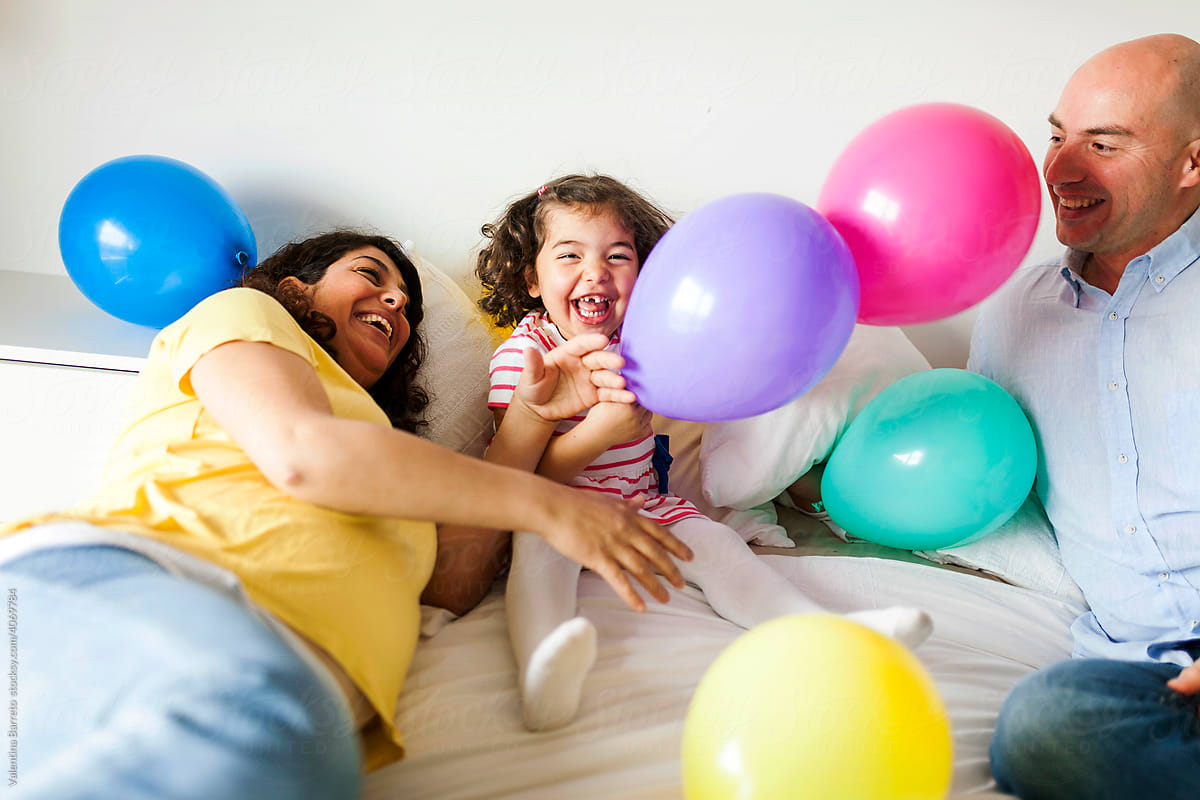 playful family playing with balloons