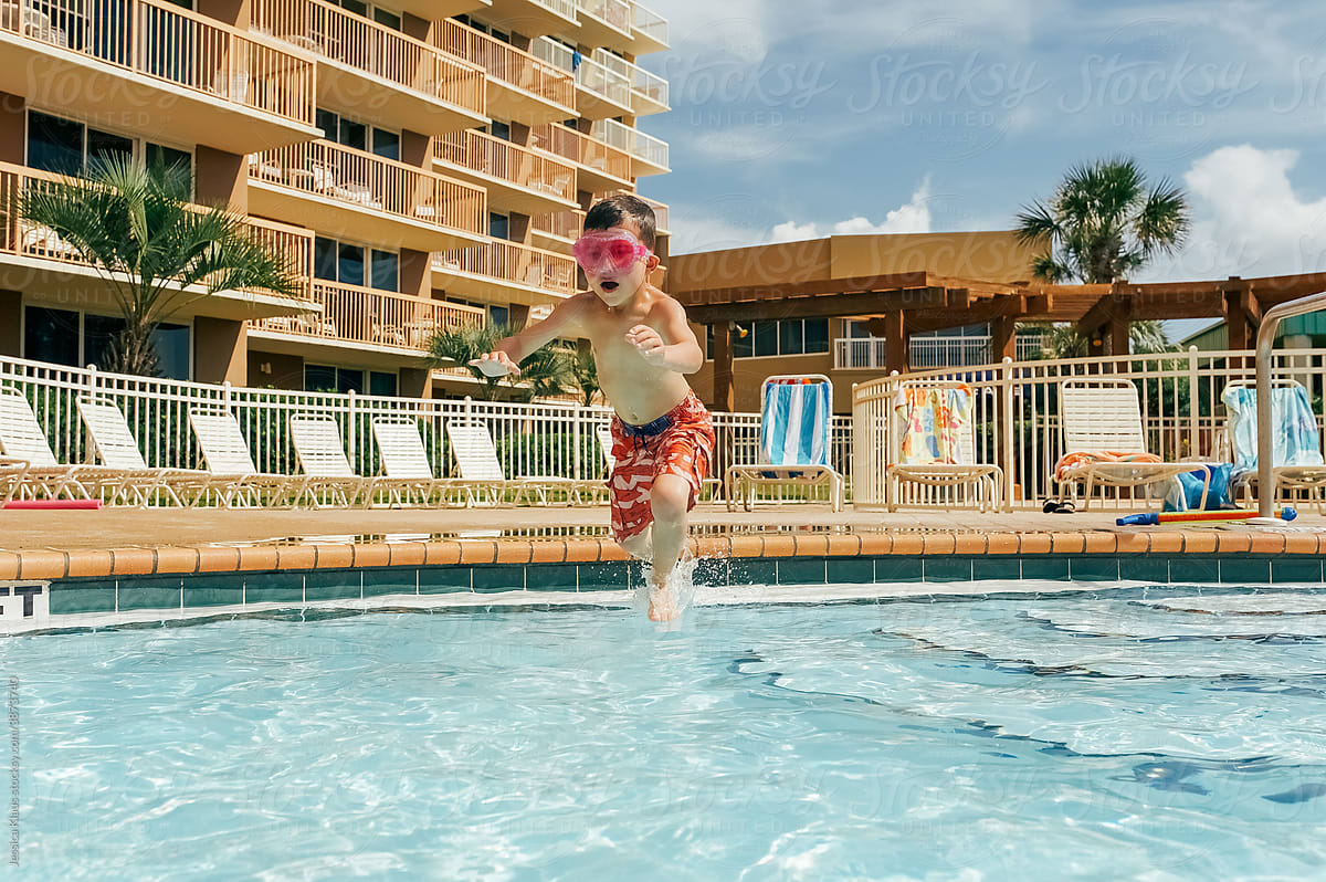 Child diving into a refreshing swimming pool.