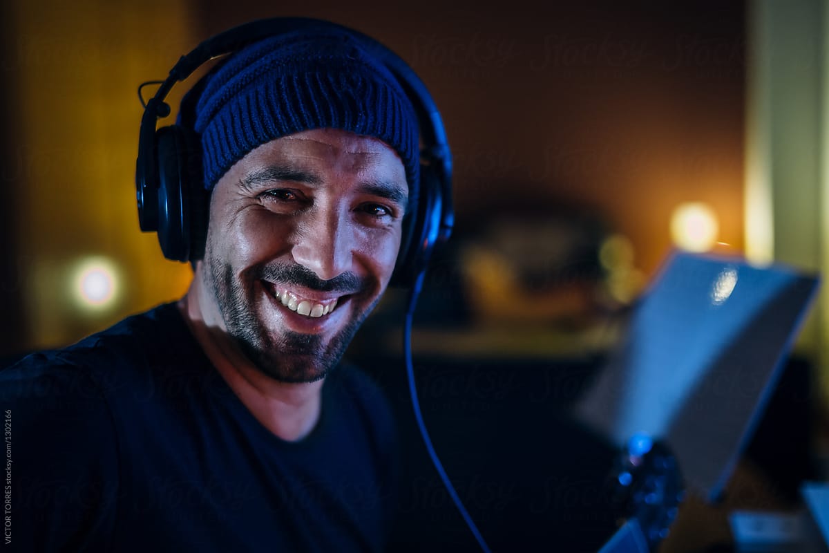 Portrait of music composer wearing headphones