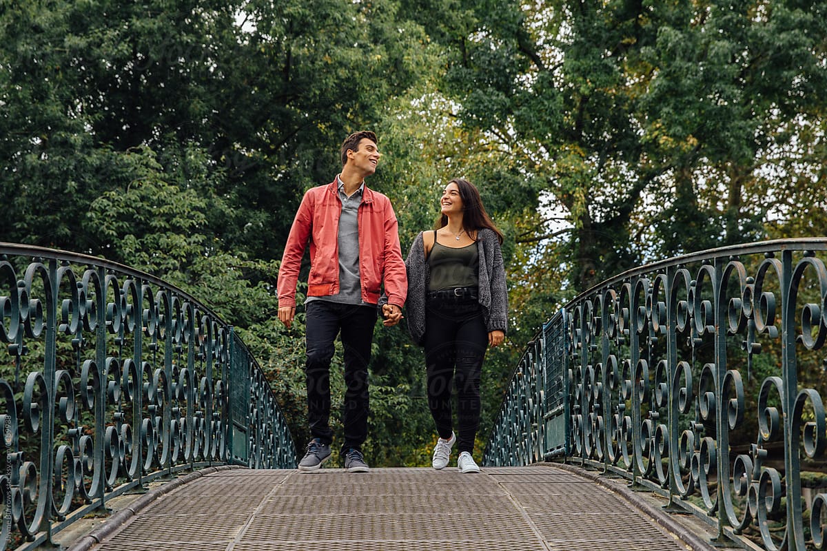 A Couple Strolls Over A Bridge By Stocksy Contributor Jayme Burrows
