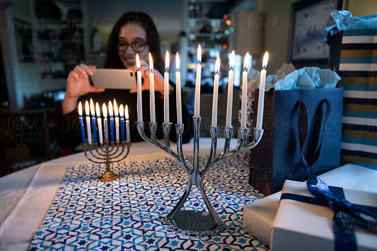 Hanukkah: Focus On Menorah As Teen Takes Photo In Background