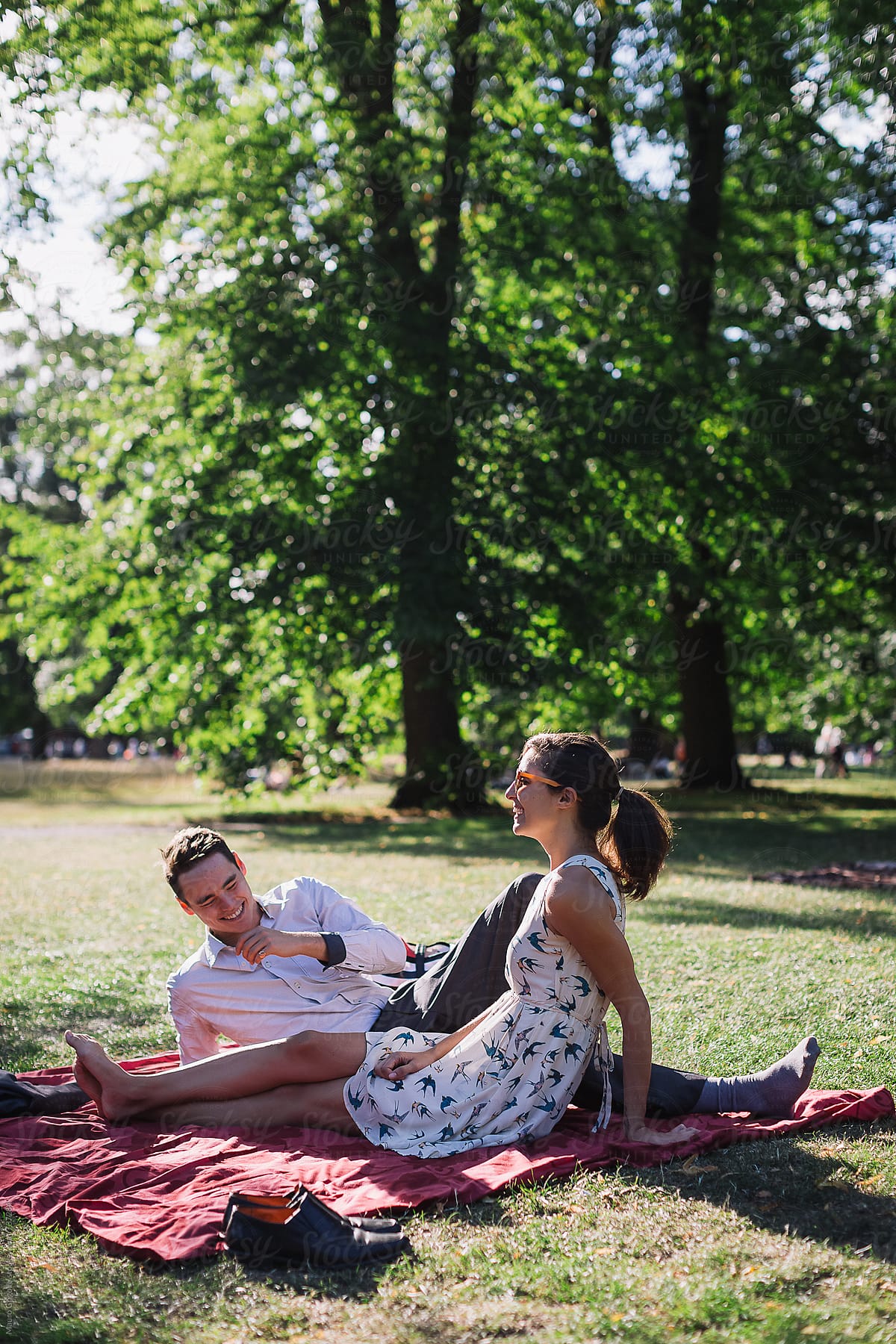 Lovers Relax And Have Fun In A Park By Stocksy Contributor Mauro Grigollo Stocksy