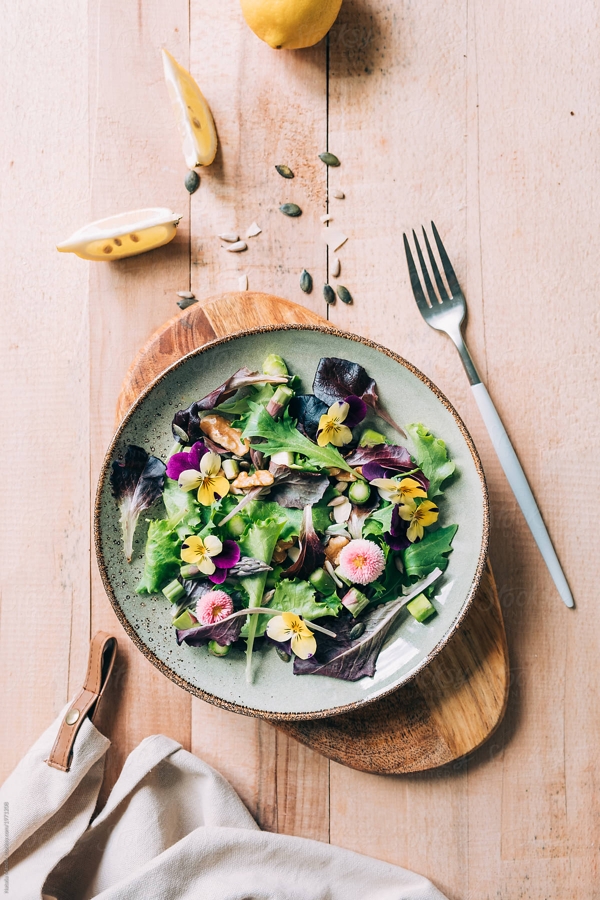 Delicious fresh salad with asparagus, english daisy and pansy