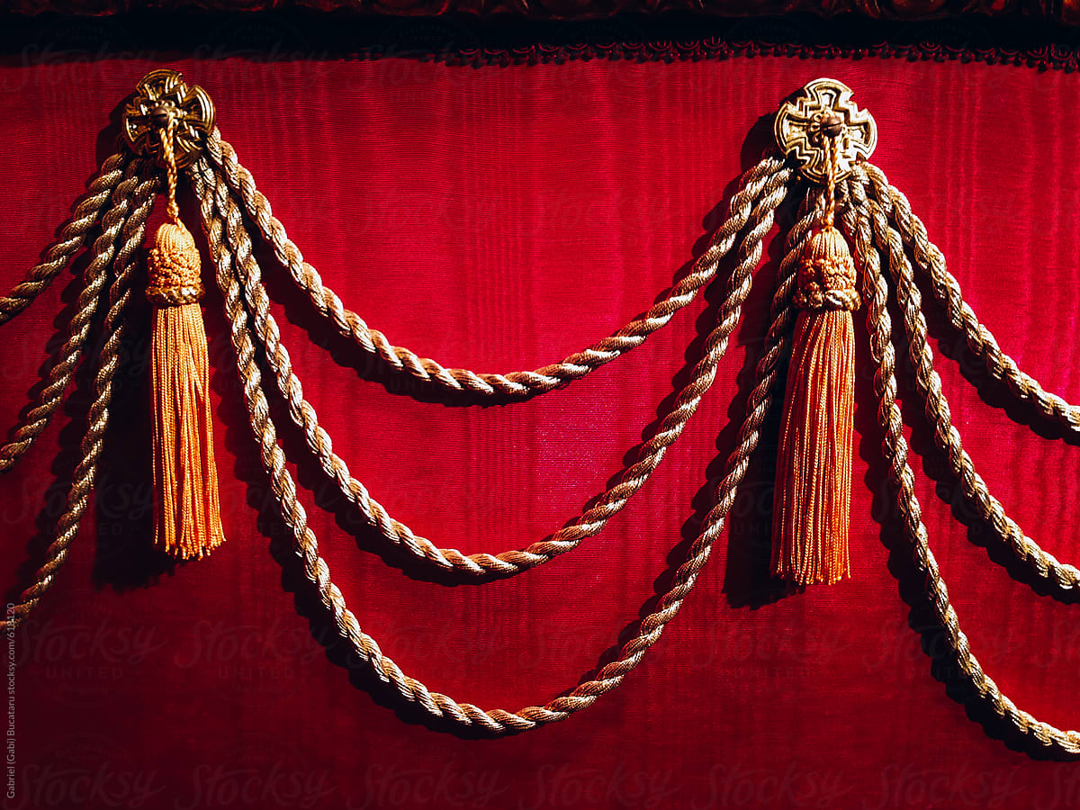 Decorative cords and frills on the side of a puppet theater stage
