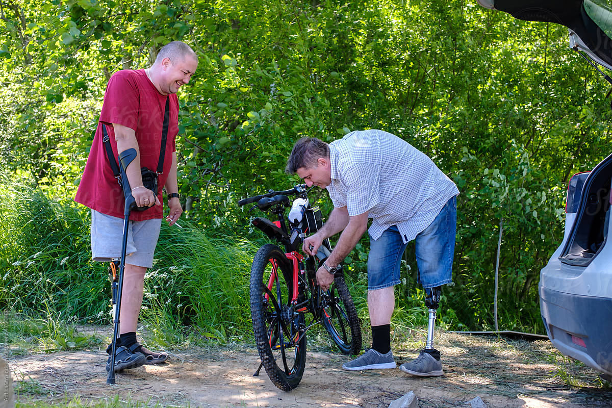 friends with physical disabilities pump up the bike