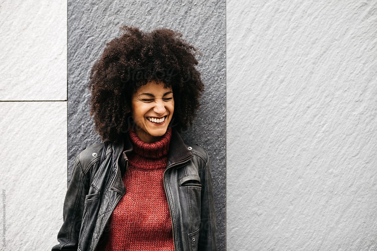 Stylish woman in leather jacket smiling