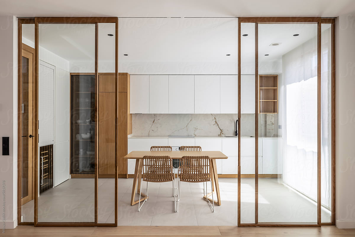 A spacious and modern kitchen with opening glass doors