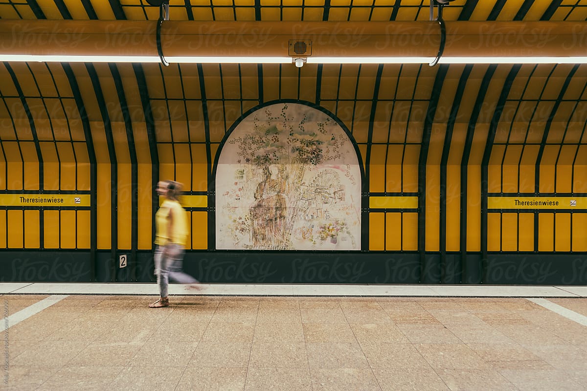 Young beautiful woman in yellow shirt walking in subway station