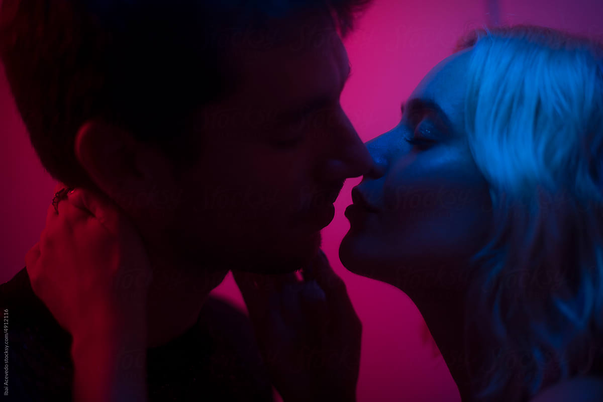 Tender dreamy kiss between lovers at night club