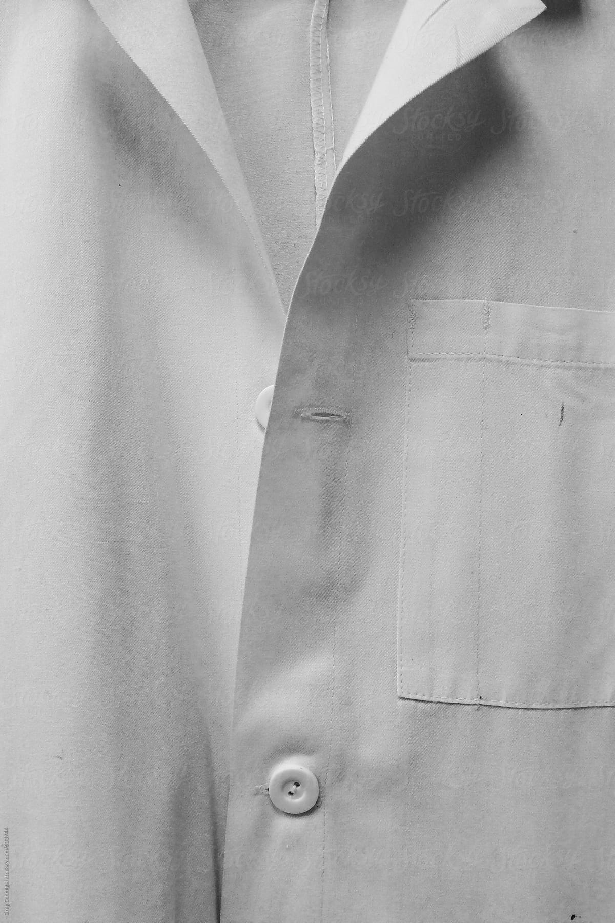 A white hospital doctor lab coat jacket with buttons in black and white