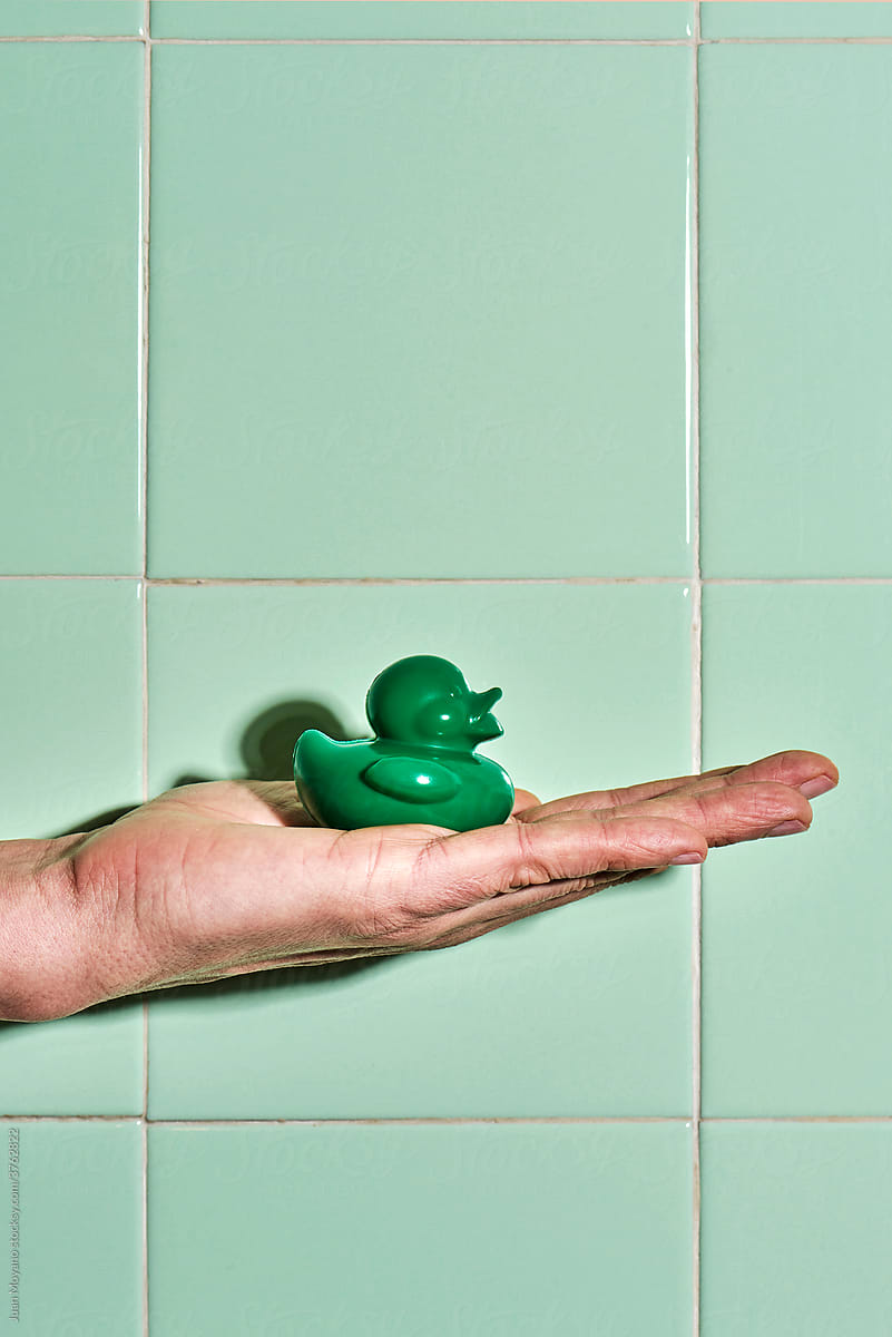 man with a green rubber duck in his hand