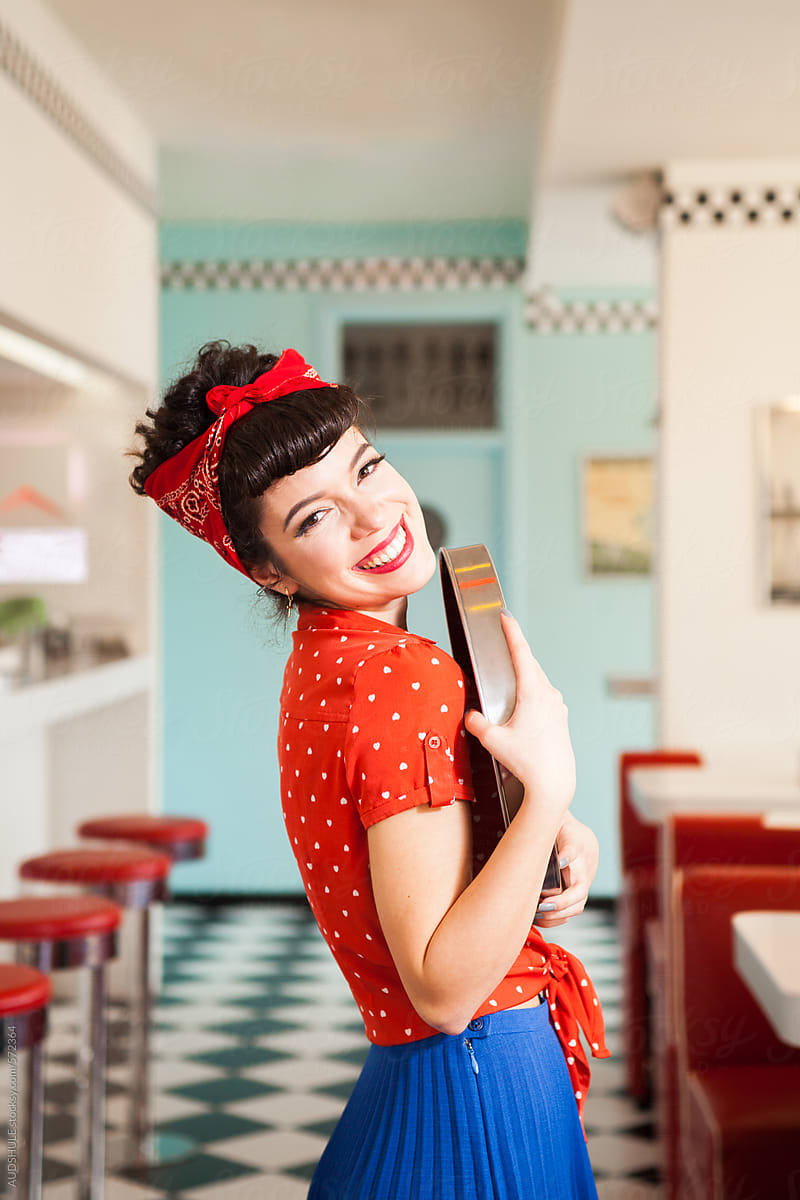 Portrait of smiling waitress in vintage outfit.