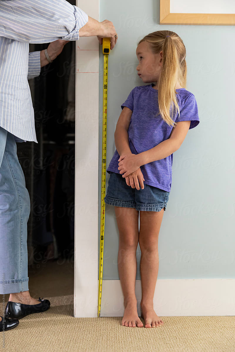 Young Girl Measuring her height at home