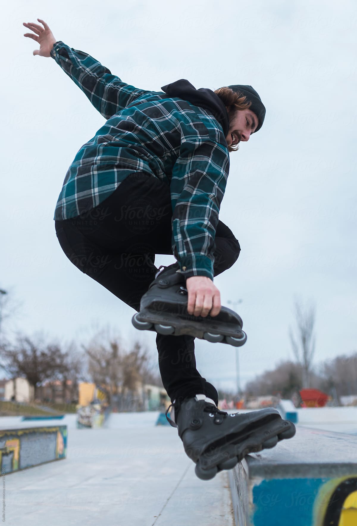Cool man doing jump in rollerblades