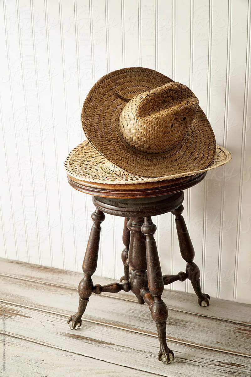 Old straw hats on wood bench