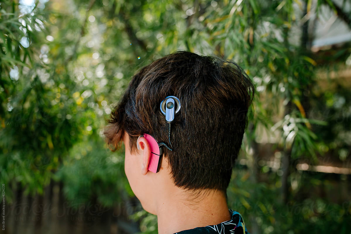 Back view of teen boy with Cochlear implants