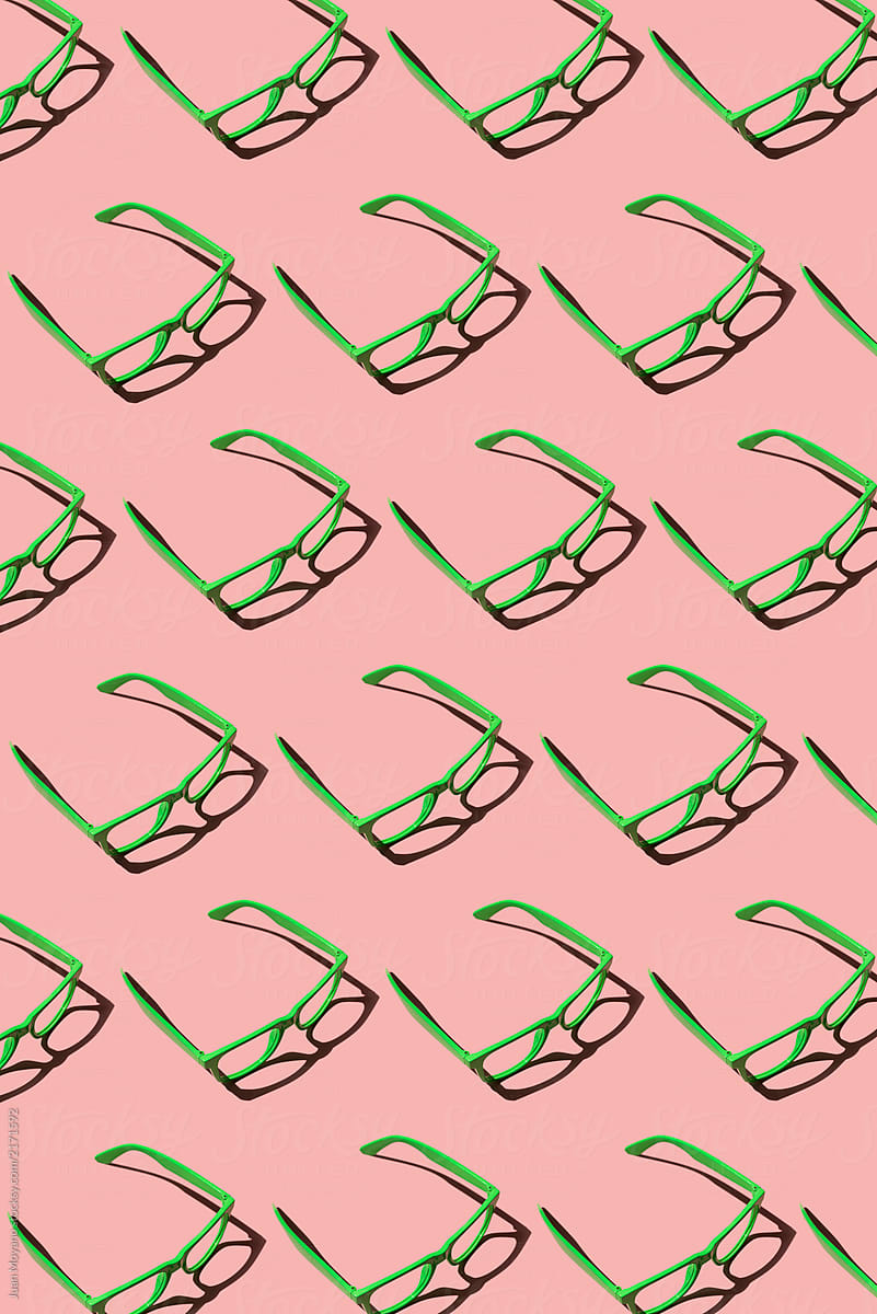 green eyeglasses on a pink background
