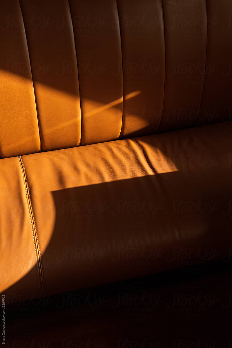 Brown leather sofa with hard direct sunlight