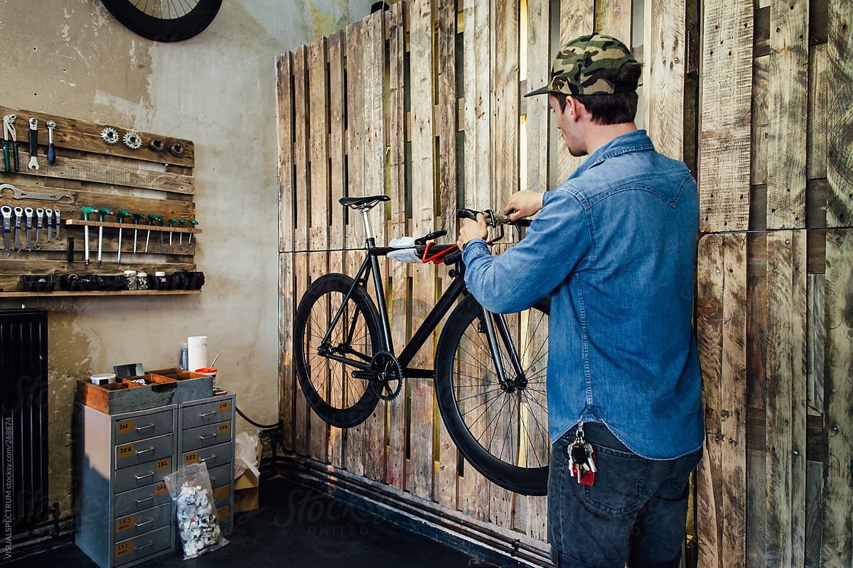 Young Man Fixing Bike in Trendy Bike Shop
