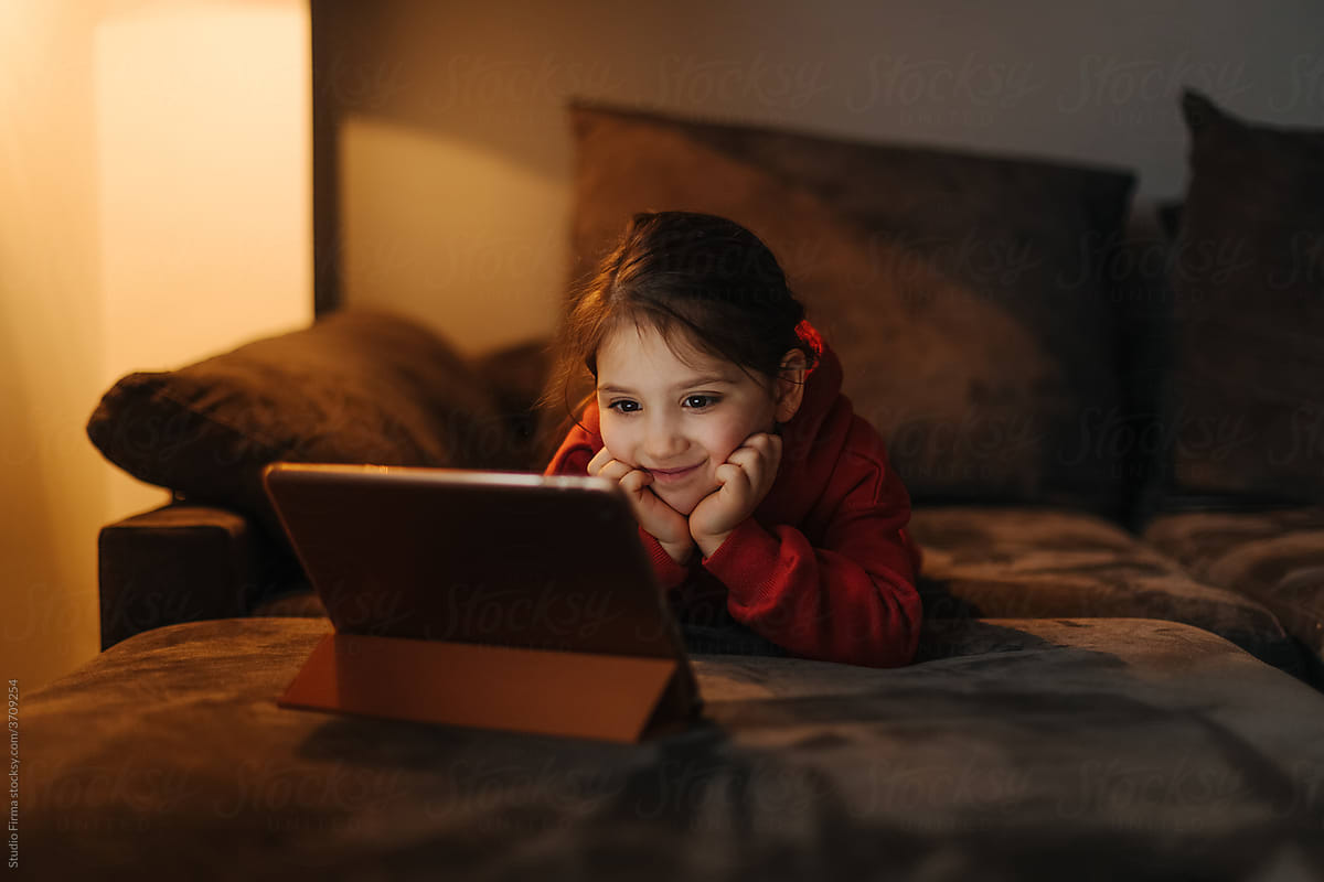 Little Girl Watching Cartoons on a Digital Tablet