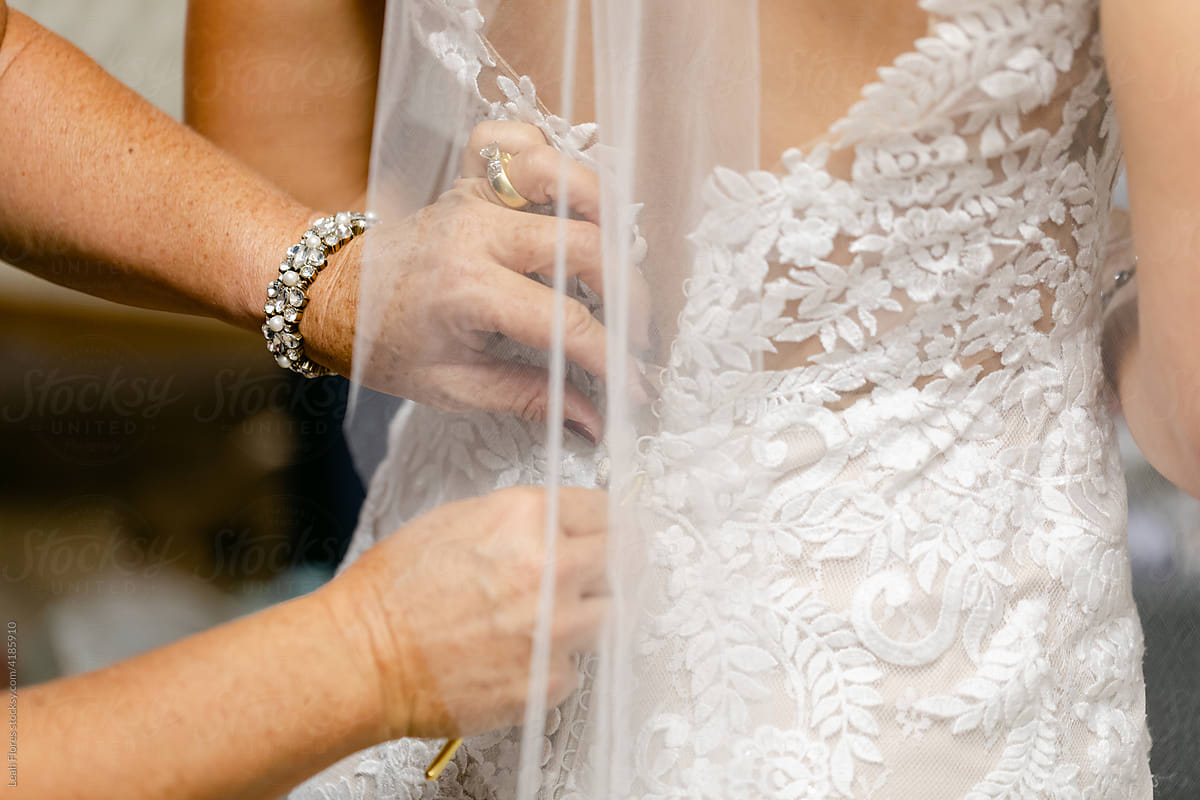Woman Buttoning Wedding Dress