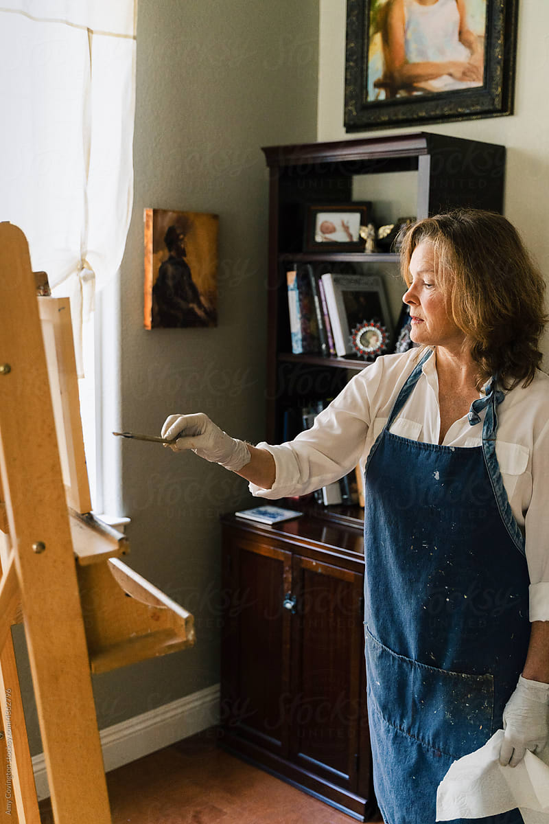 An artist painting in her studio