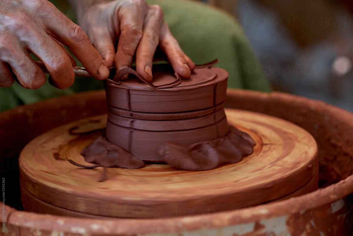 Potter Trimming A Terracotta Pot On His Potter\'s Wheel