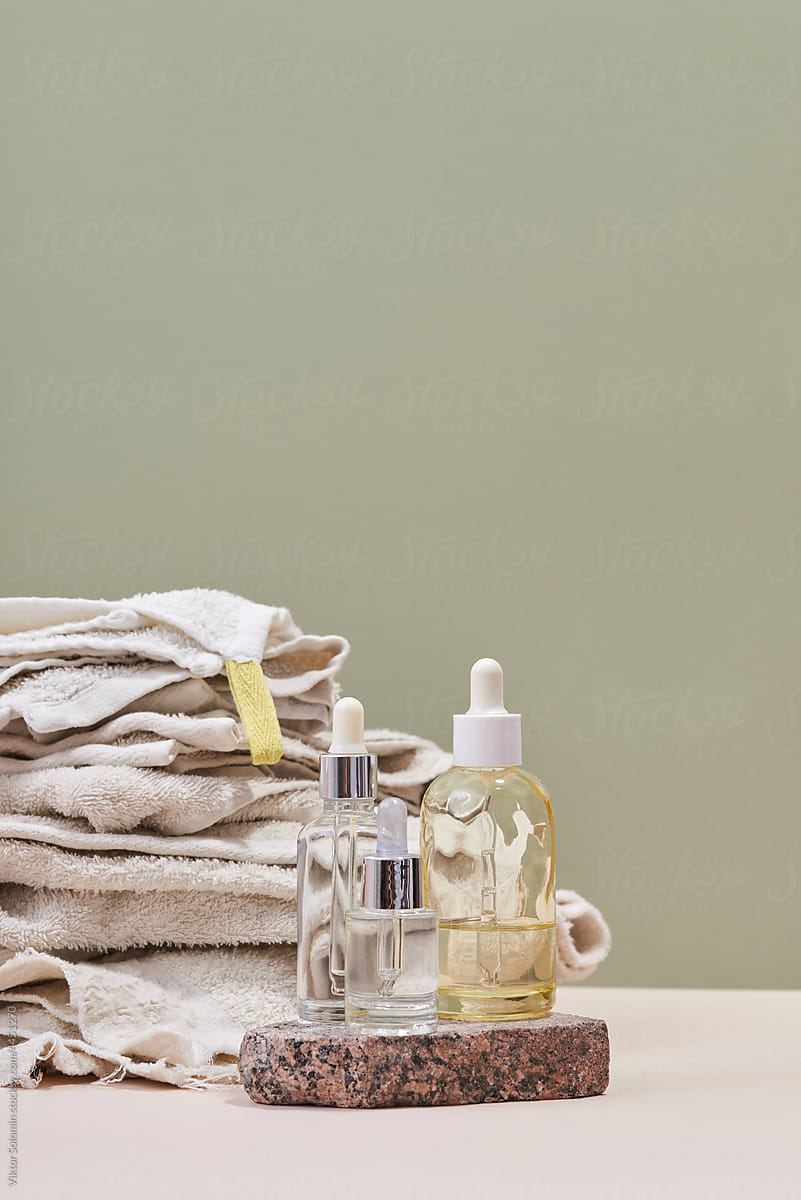 Bottles of skin care products and towels