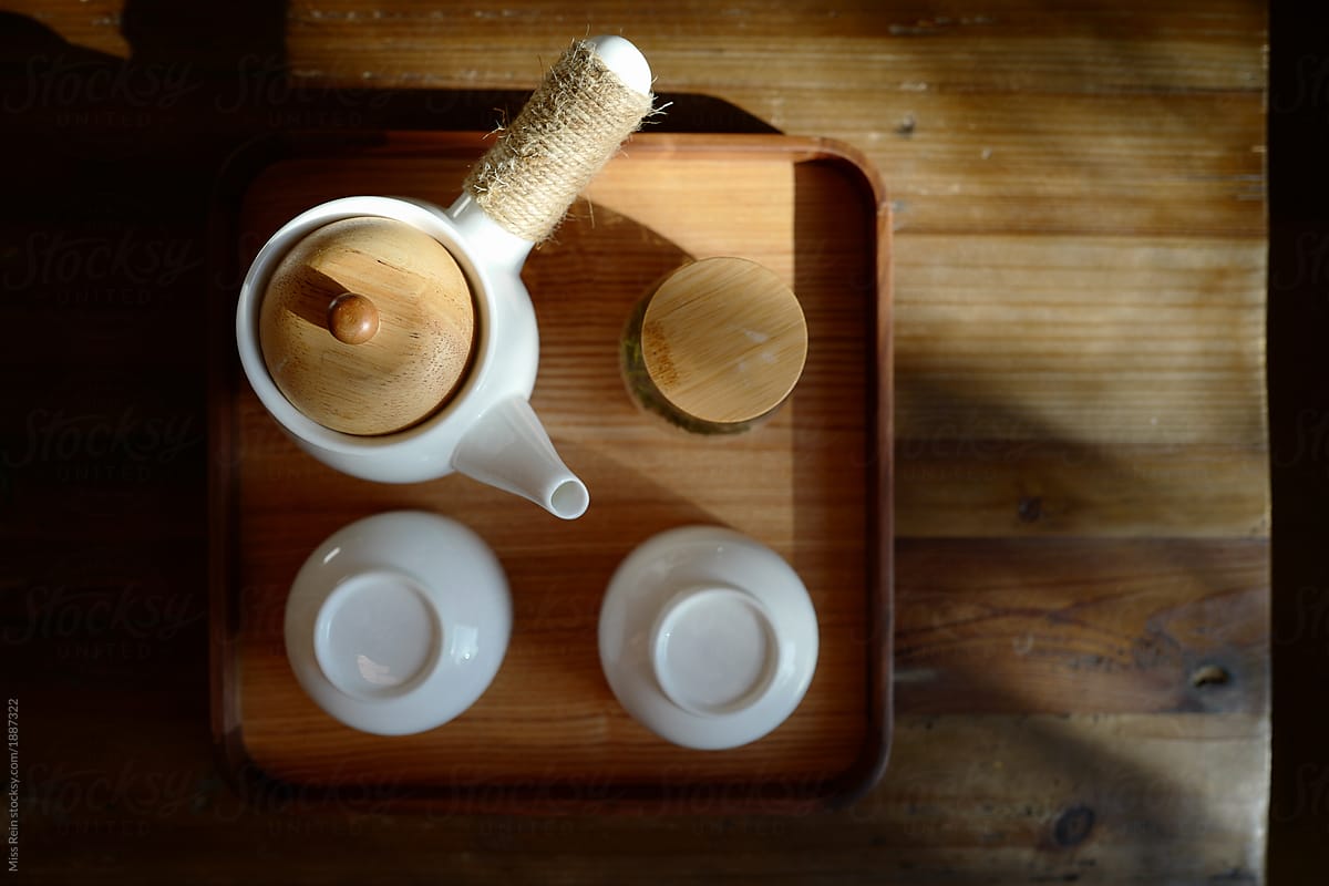 Chinese teapot and china tea cup on wooden table