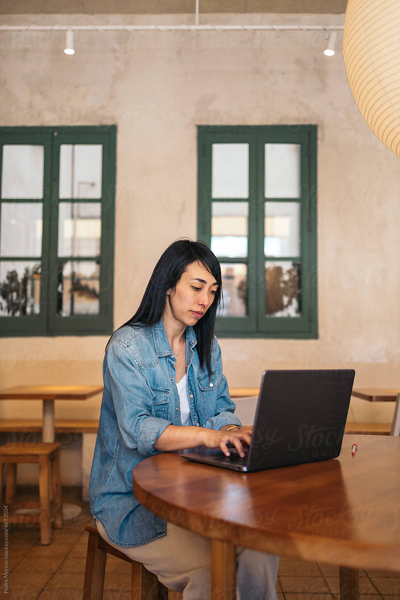 Asian woman working remotely in a coworking space