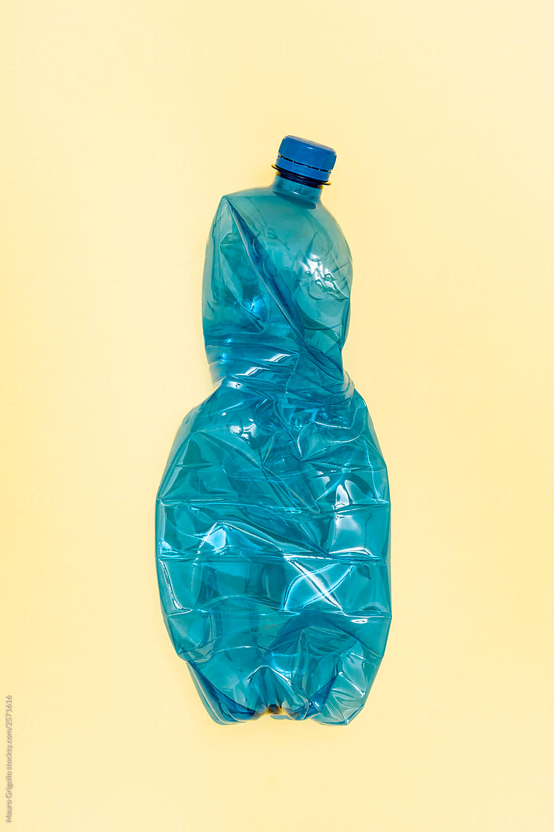 Blue Plastic Bottle On yellow Background. Recycle.
