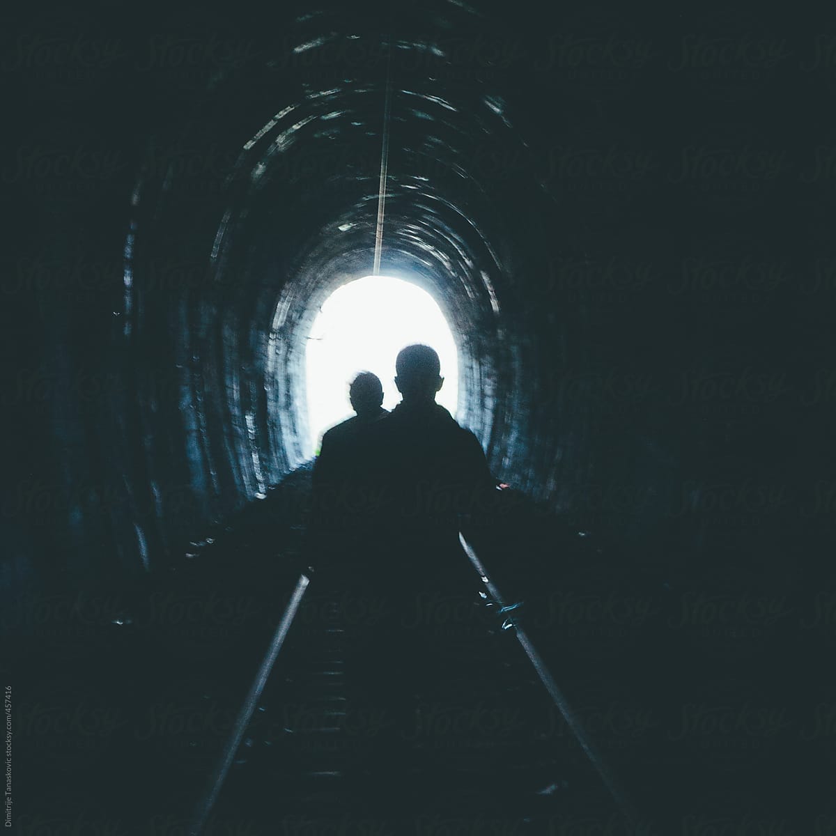 Two guys walking on abandoned rail