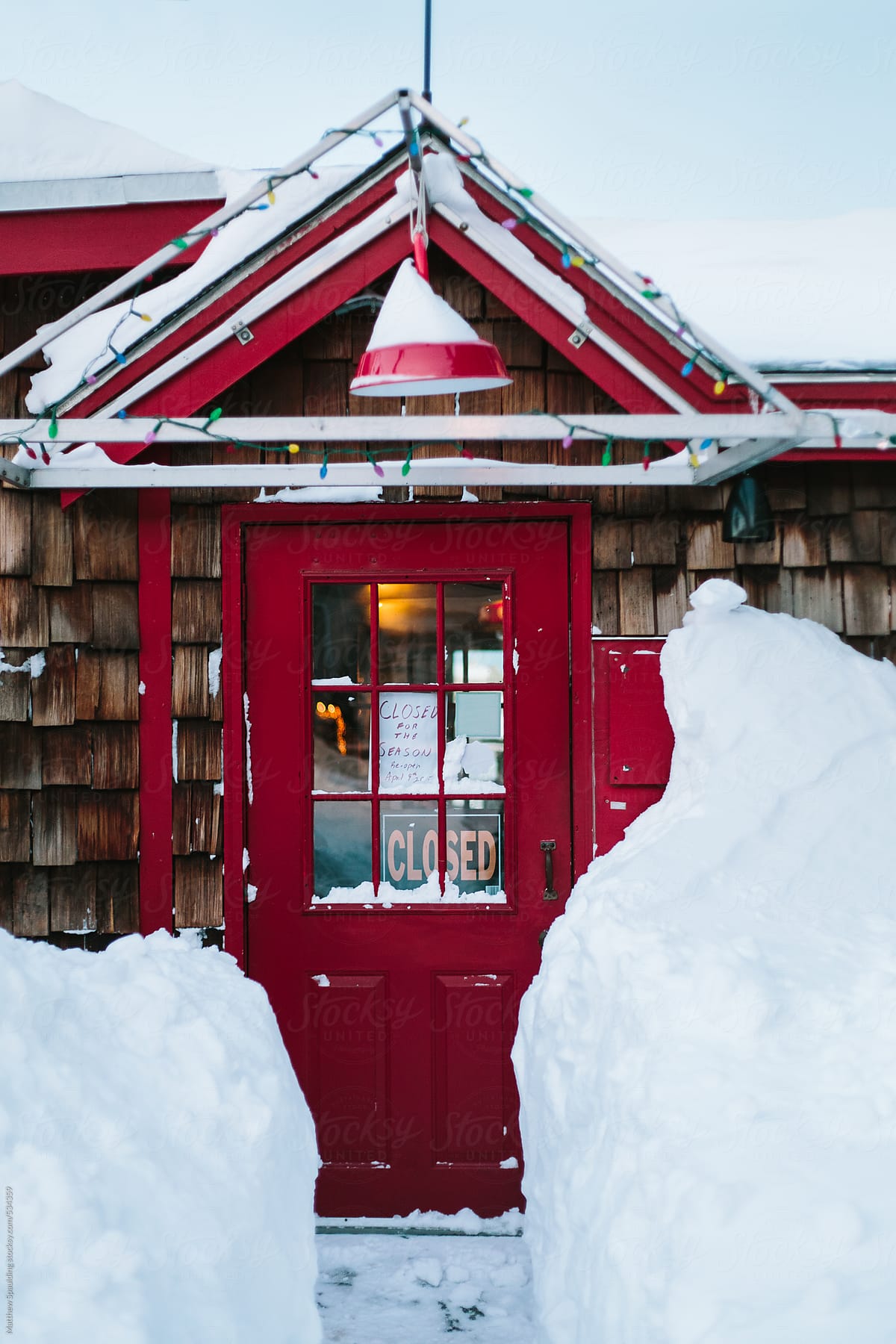 Restaurant building with closed for season sign in deep snow