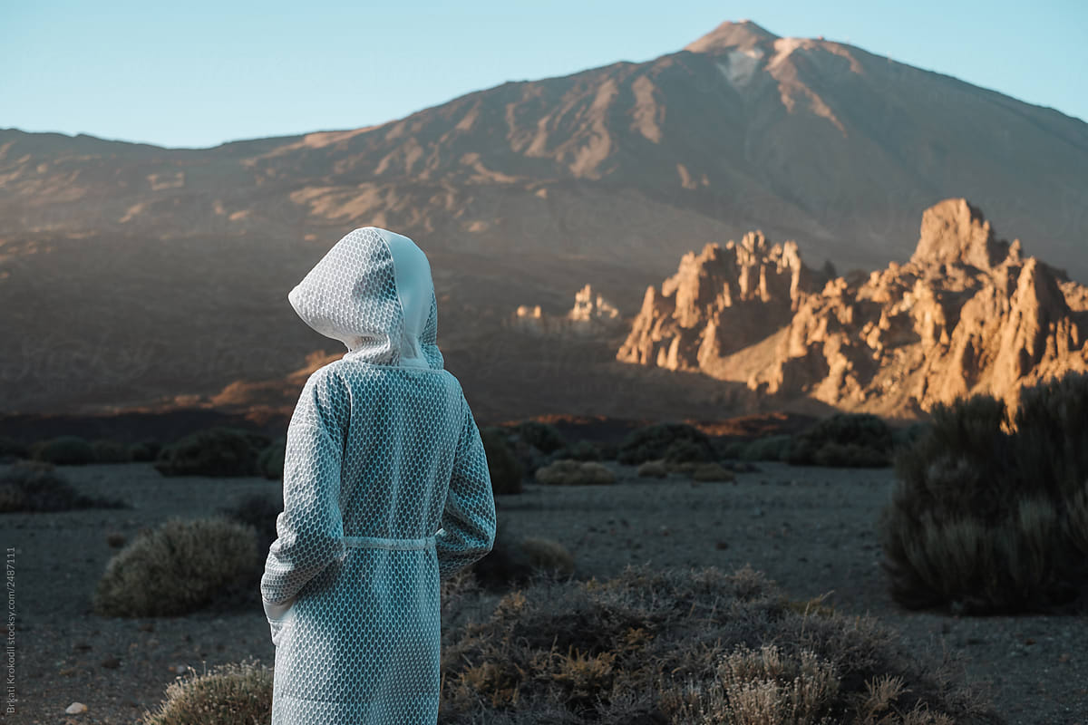 Anonymous Model Wearing Futuristic White Coat In The Volcanic Scenery