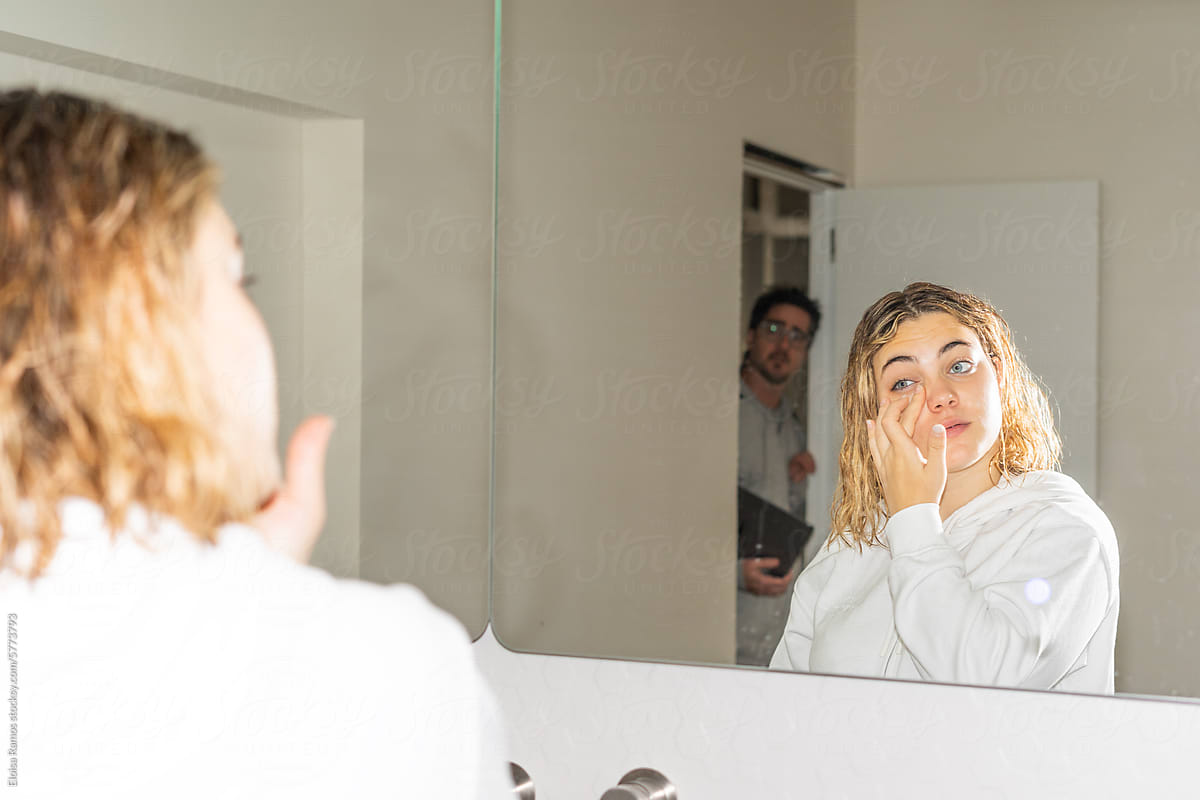 woman doing Morning Skincare Routine and talking with her father