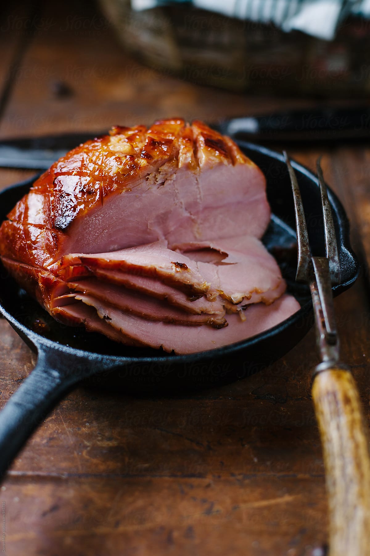 Baked ham in a cast iron skillet.