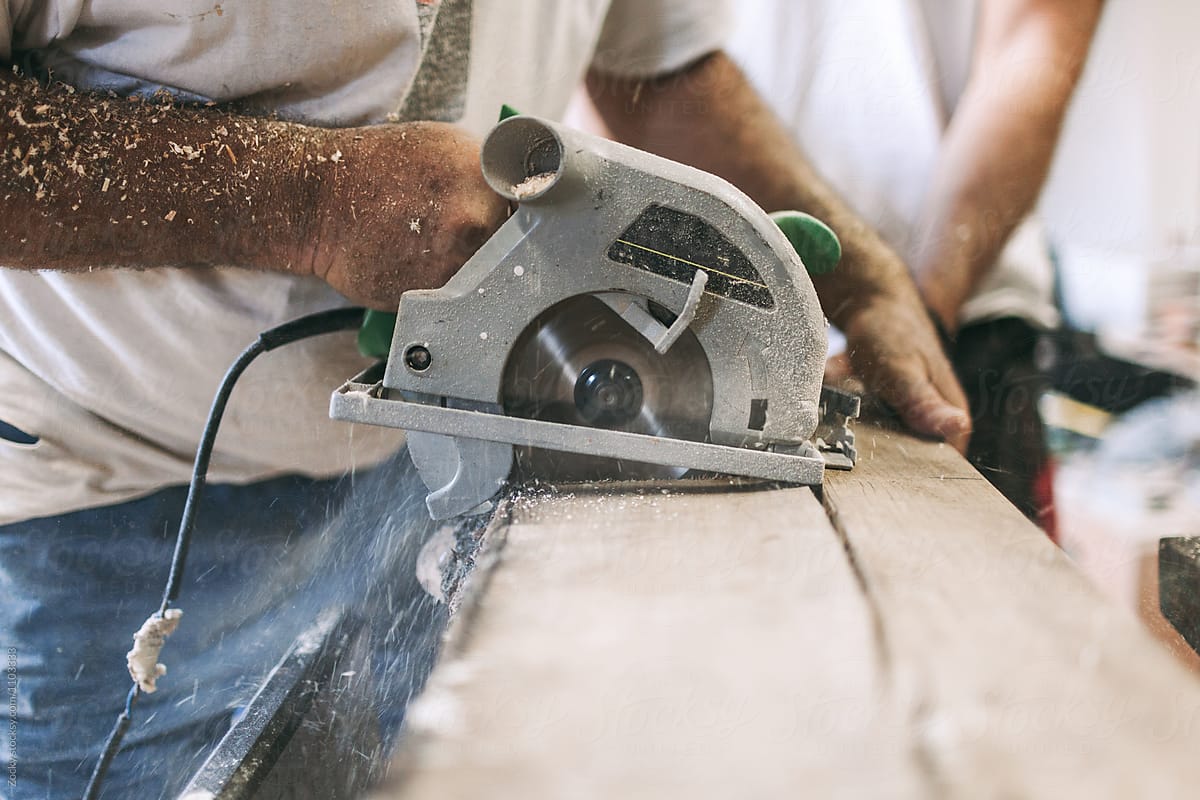 Carpenter\'s Hands Cutting Wood With a Circular Saw