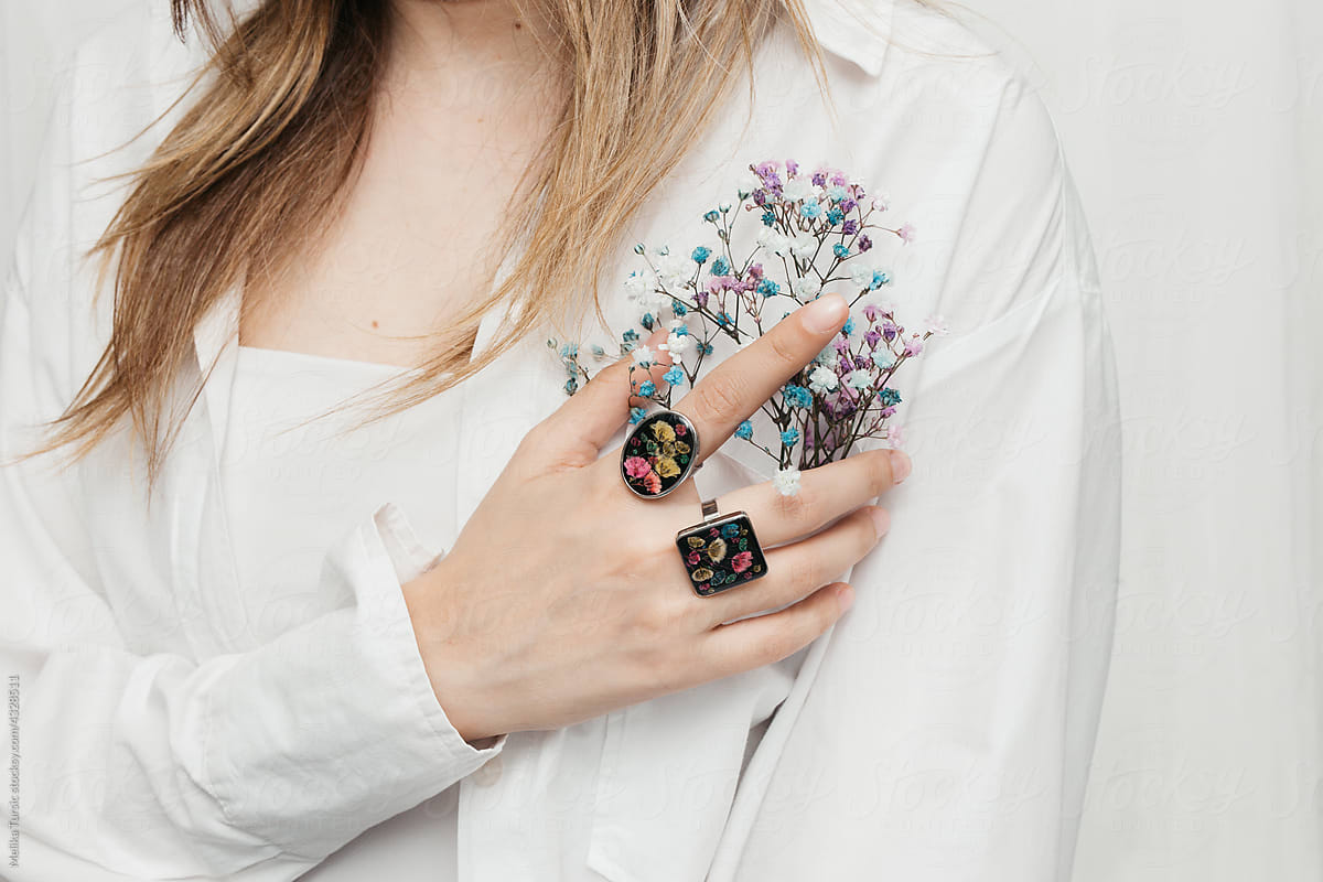 woman wearing floral epoxy rings